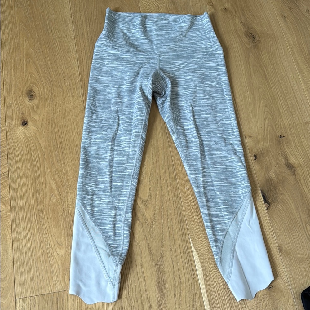 Lululemon Gray Marl High-Waisted Leggings with scalloped hem and mesh detail.